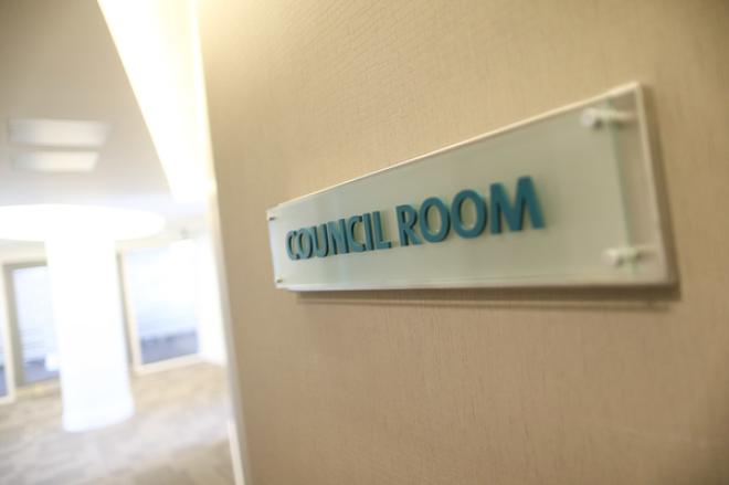 Sign on wall reads 'Council Room', indicating meeting space